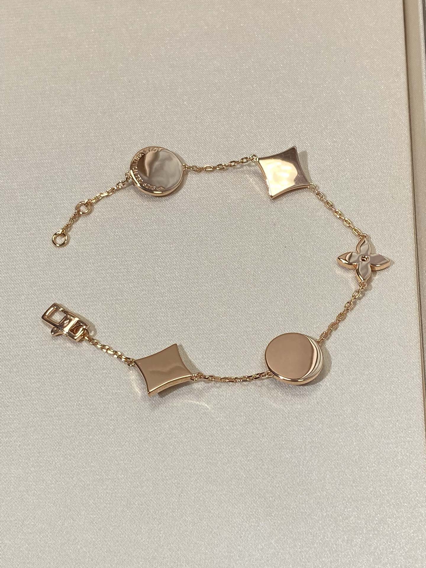 GlowSTAR AND SUN 5 MOTIF MOP PINK GOLD BRACELET